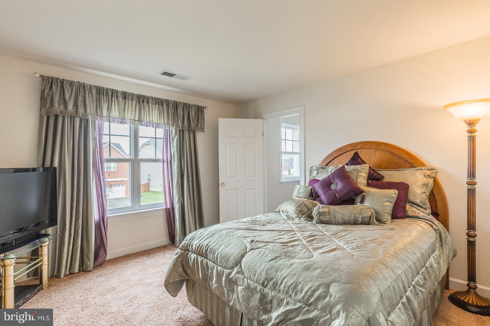 4157 Agency Loop Triangle, VA 22172 - Photo 21 of 30 a bed sitting in a bedroom next to a window