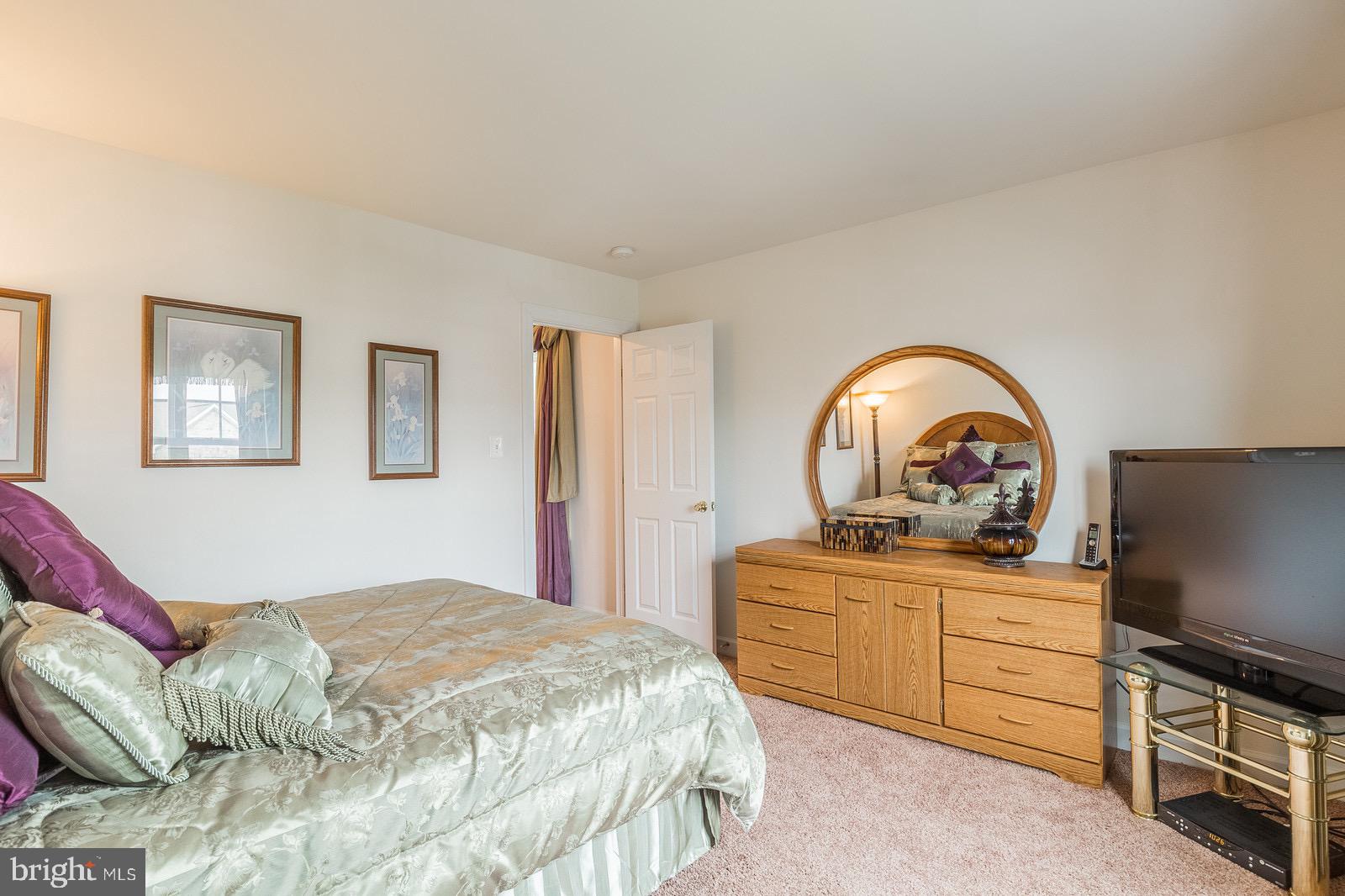 4157 Agency Loop Triangle, VA 22172 - Photo 22 of 30 a bedroom with a bed and a flat screen tv