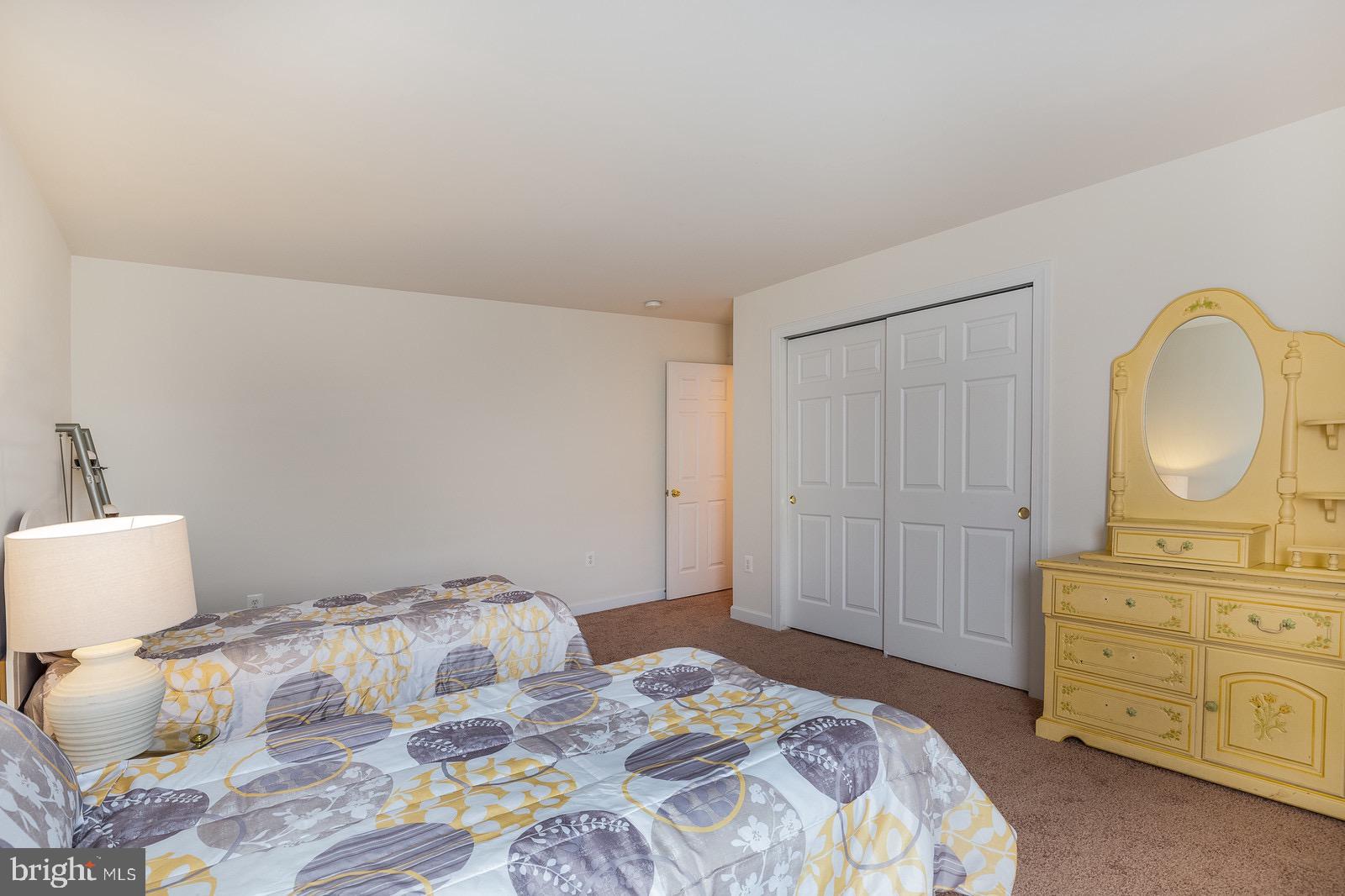 4157 Agency Loop Triangle, VA 22172 - Photo 23 of 30 a bedroom with a bed and a dresser