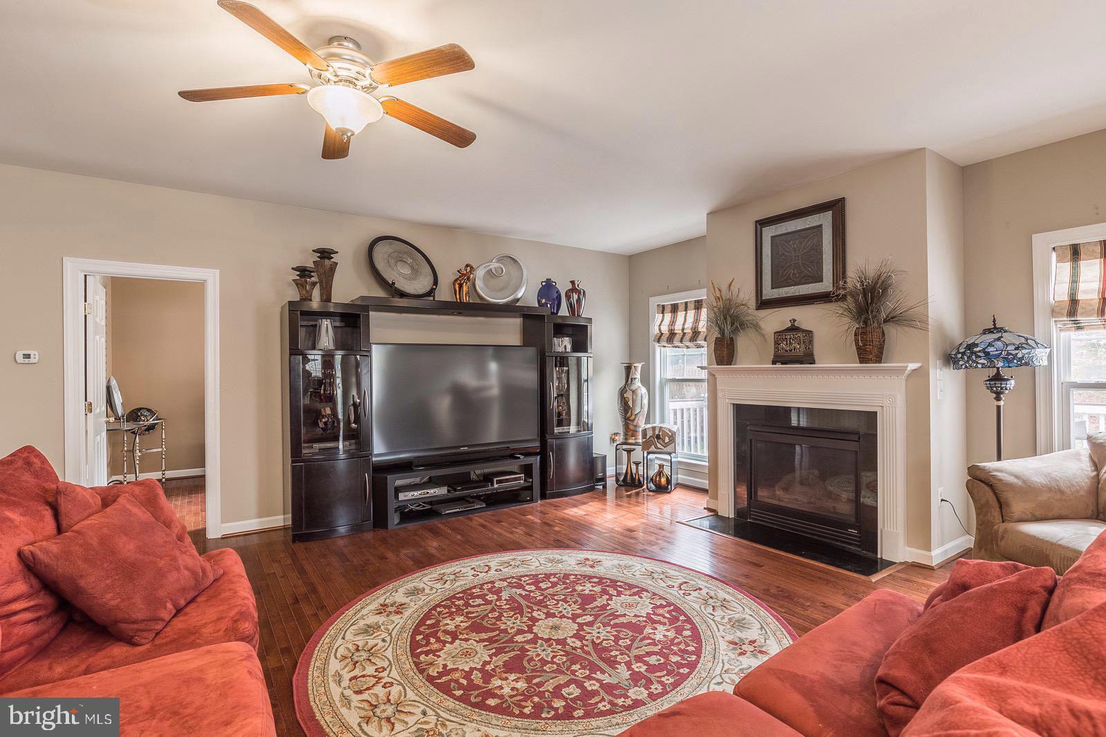 4157 Agency Loop Triangle, VA 22172 - Photo 4 of 30 a living room with furniture a flat screen tv and a fireplace