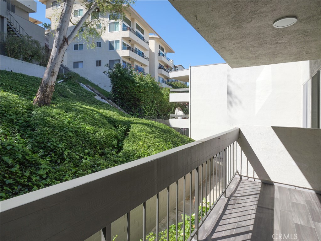 28121 Highridge Road, Unit 311 Rancho Palos Verdes, CA 90275 - Photo 15 of 25 a view of a balcony with wooden fence and floor