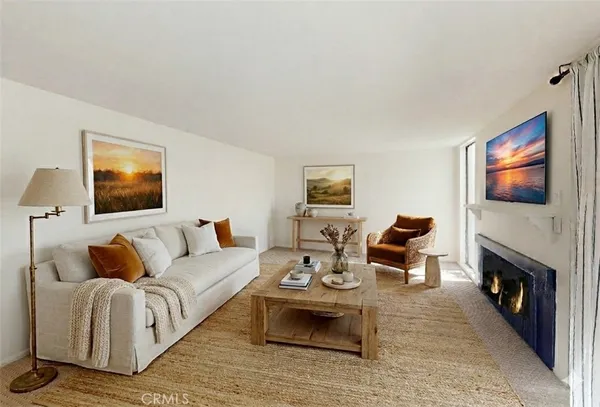 a living room with furniture a flat screen tv and a fireplace