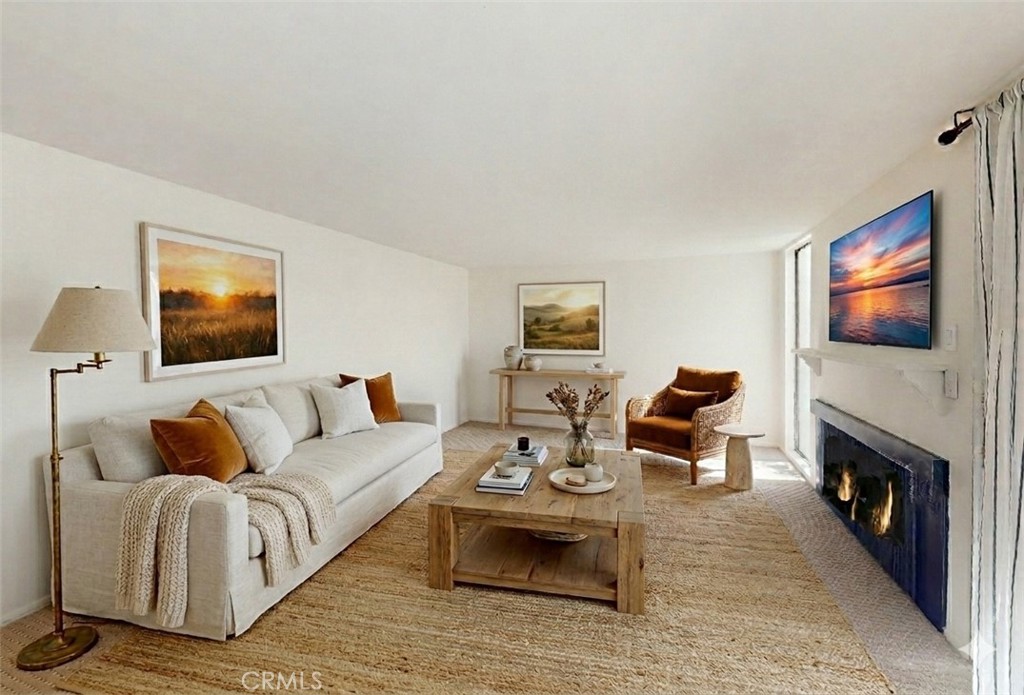 28121 Highridge Road, Unit 311 Rancho Palos Verdes, CA 90275 - Photo 2 of 25 a living room with furniture a flat screen tv and a fireplace