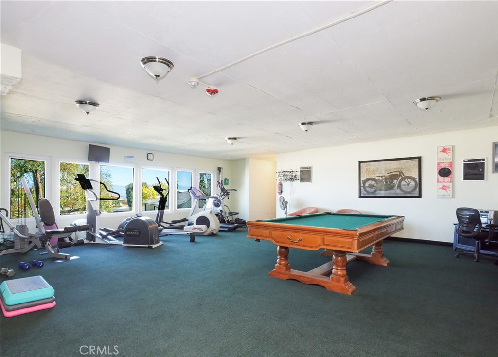 28121 Highridge Road, Unit 311 Rancho Palos Verdes, CA 90275 - Photo 21 of 25 a living room with furniture pool table and large windows