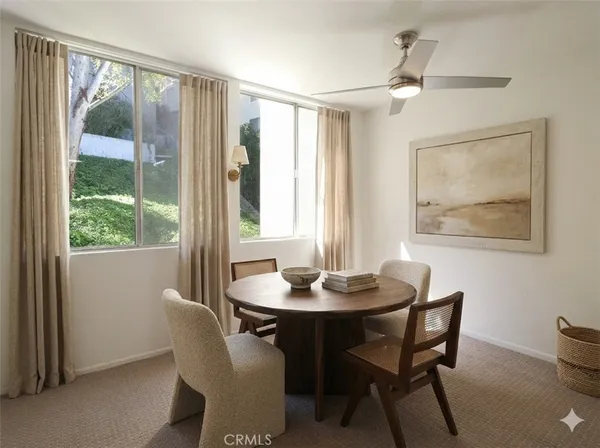 a dining room with furniture window and wooden floor