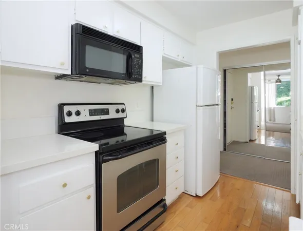 a kitchen with a stove microwave and refrigerator
