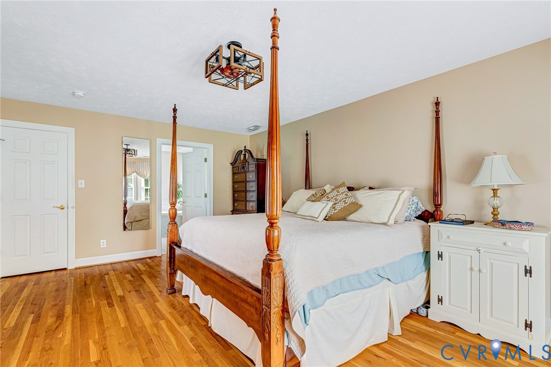 5629 West Quaker Road Disputanta, VA 23842 - Photo 16 of 43 Bedroom with light wood finished floors and basebo