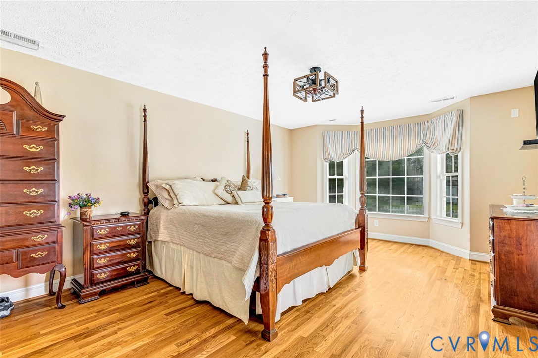 5629 West Quaker Road Disputanta, VA 23842 - Photo 17 of 43 Bedroom with light wood-style flooring, baseboards