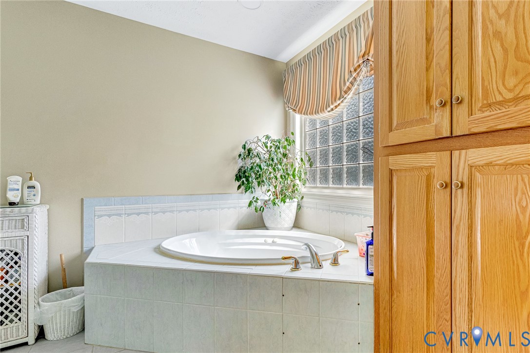 5629 West Quaker Road Disputanta, VA 23842 - Photo 19 of 43 Bathroom with a garden tub and tile patterned floo