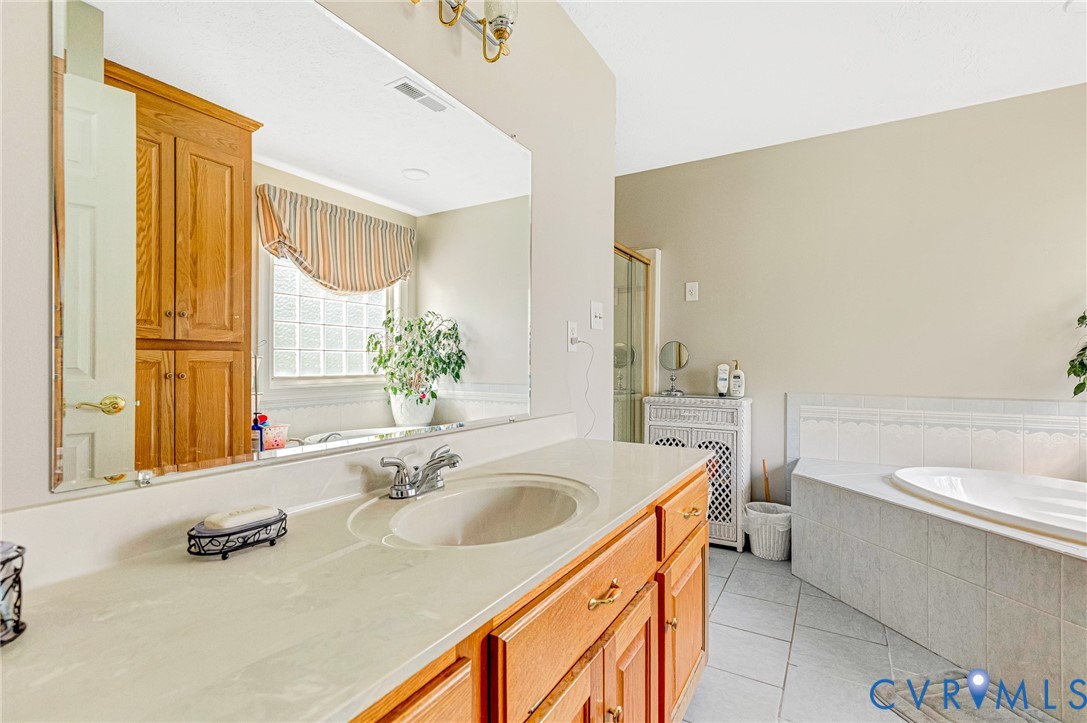 5629 West Quaker Road Disputanta, VA 23842 - Photo 20 of 43 Bathroom with tile patterned floors, vanity, a bat