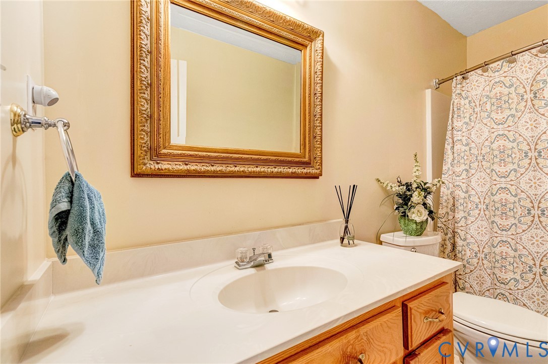 5629 West Quaker Road Disputanta, VA 23842 - Photo 23 of 43 Hall bathroom with a shower, and vanity