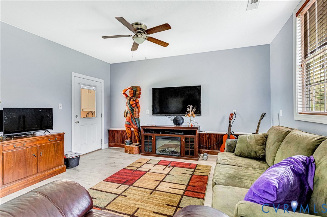 5629 West Quaker Road Disputanta, VA 23842 - Photo 27 of 43 Living area with wood finished floors, ceiling fan