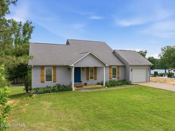 a front view of house with yard and green space