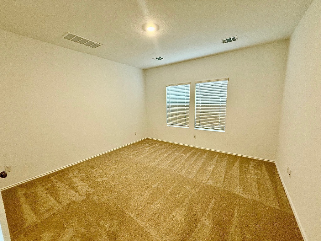 1724 Four Waters Loop Georgetown, TX 78628 - Photo 10 of 38 Spare room with carpet and baseboards