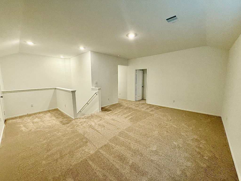 1724 Four Waters Loop Georgetown, TX 78628 - Photo 14 of 38 Bonus Room with vaulted ceiling, light colored carpet, and recessed lighting