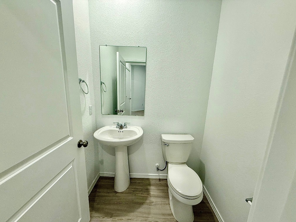 1724 Four Waters Loop Georgetown, TX 78628 - Photo 21 of 38 Bathroom featuring a textured wall and light wood-style flooring