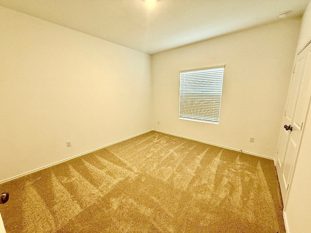 1724 Four Waters Loop Georgetown, TX 78628 - Photo 26 of 38 Gen X Bedroom suite with light colored carpet and baseboards