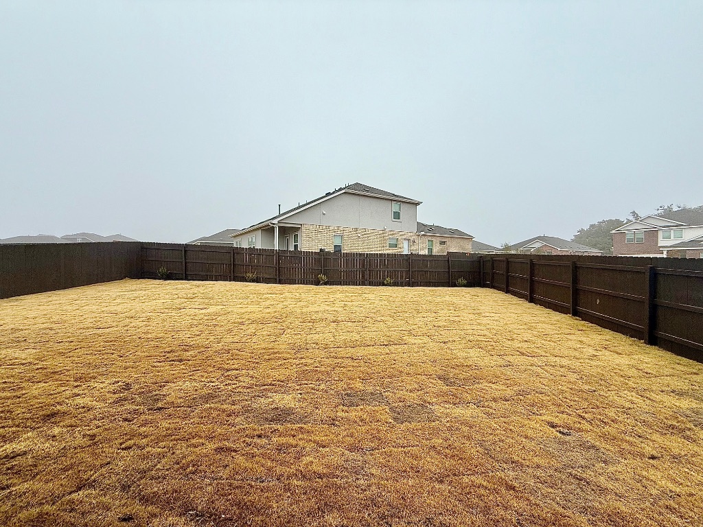 1724 Four Waters Loop Georgetown, TX 78628 - Photo 31 of 38 View of fenced backyard