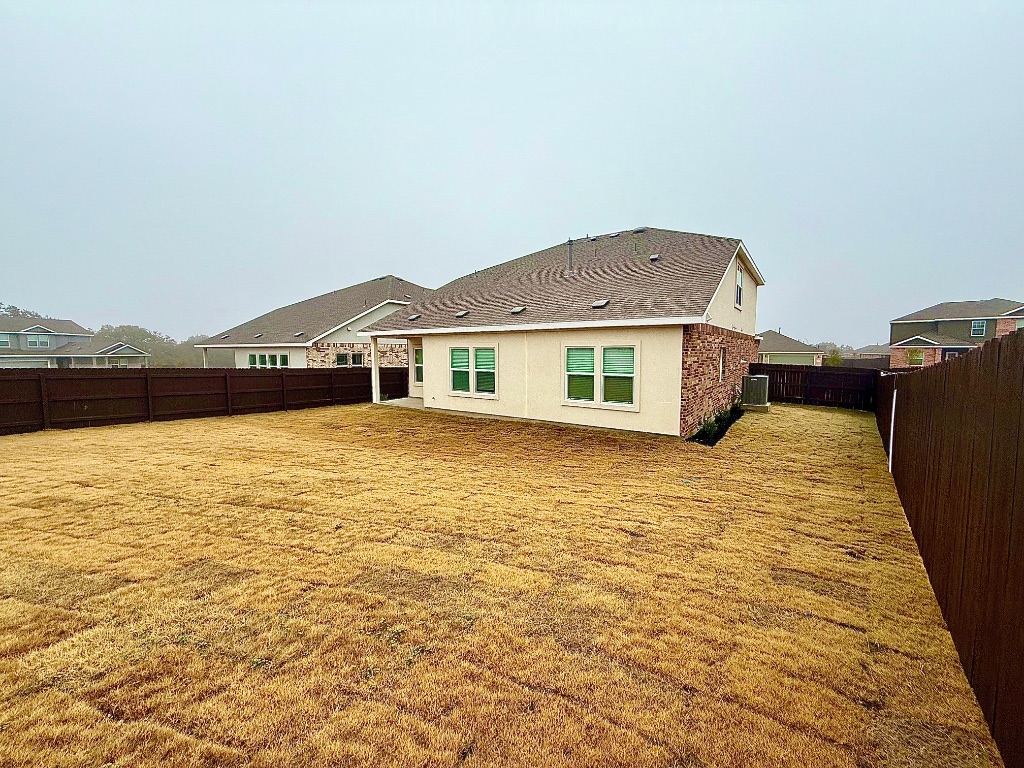 1724 Four Waters Loop Georgetown, TX 78628 - Photo 33 of 38 Back of house featuring a fenced backyard
