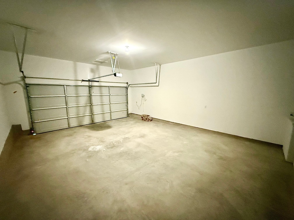 1724 Four Waters Loop Georgetown, TX 78628 - Photo 34 of 38 View of garage with automatic garage door openers with remotes.