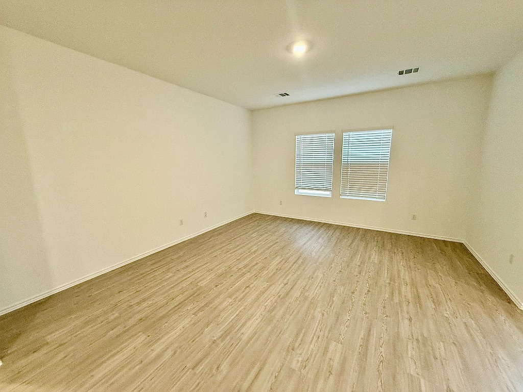 1724 Four Waters Loop Georgetown, TX 78628 - Photo 8 of 38 Living Room featuring light wood finished floors and baseboards
