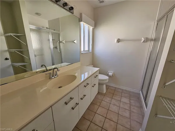a bathroom with a double vanity sink toilet and shower