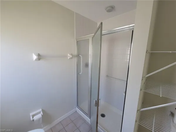 a bathroom with a glass shower door