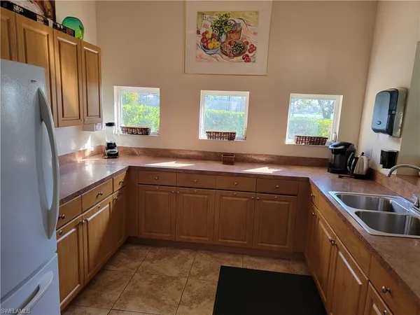 a kitchen with a sink stove and refrigerator