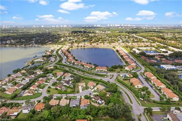 an aerial view of residential building and lake