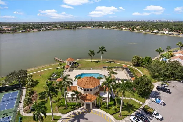 an aerial view of a house with outdoor space and lake view