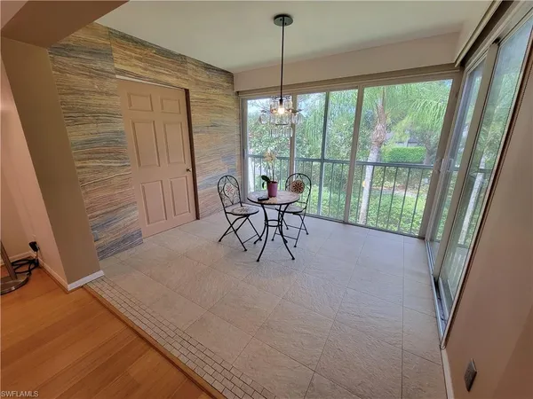 a view of a room with furniture and large windows
