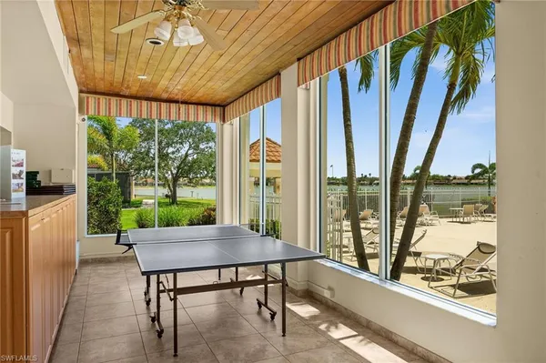 a living room with large windows and furniture