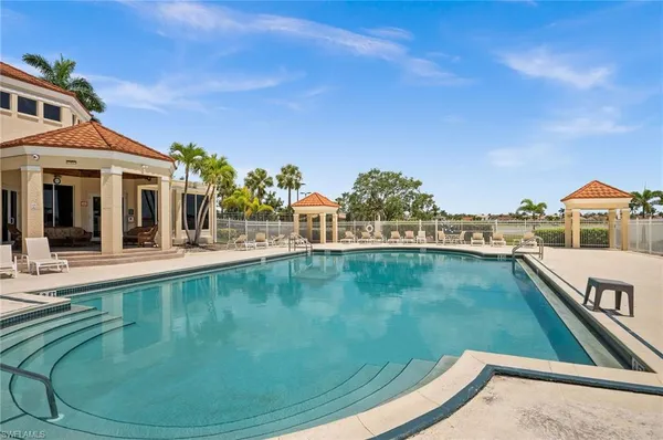 a view of a swimming pool with an outdoor seating