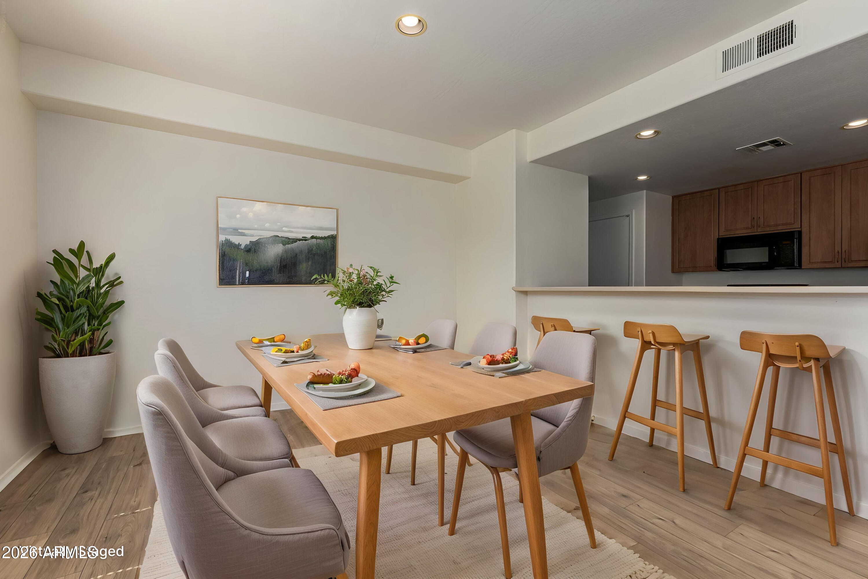 705 West Queen Creek Road, Unit 1167 Chandler, AZ 85248 - Photo 6 of 31 a dining room with furniture and wooden floor