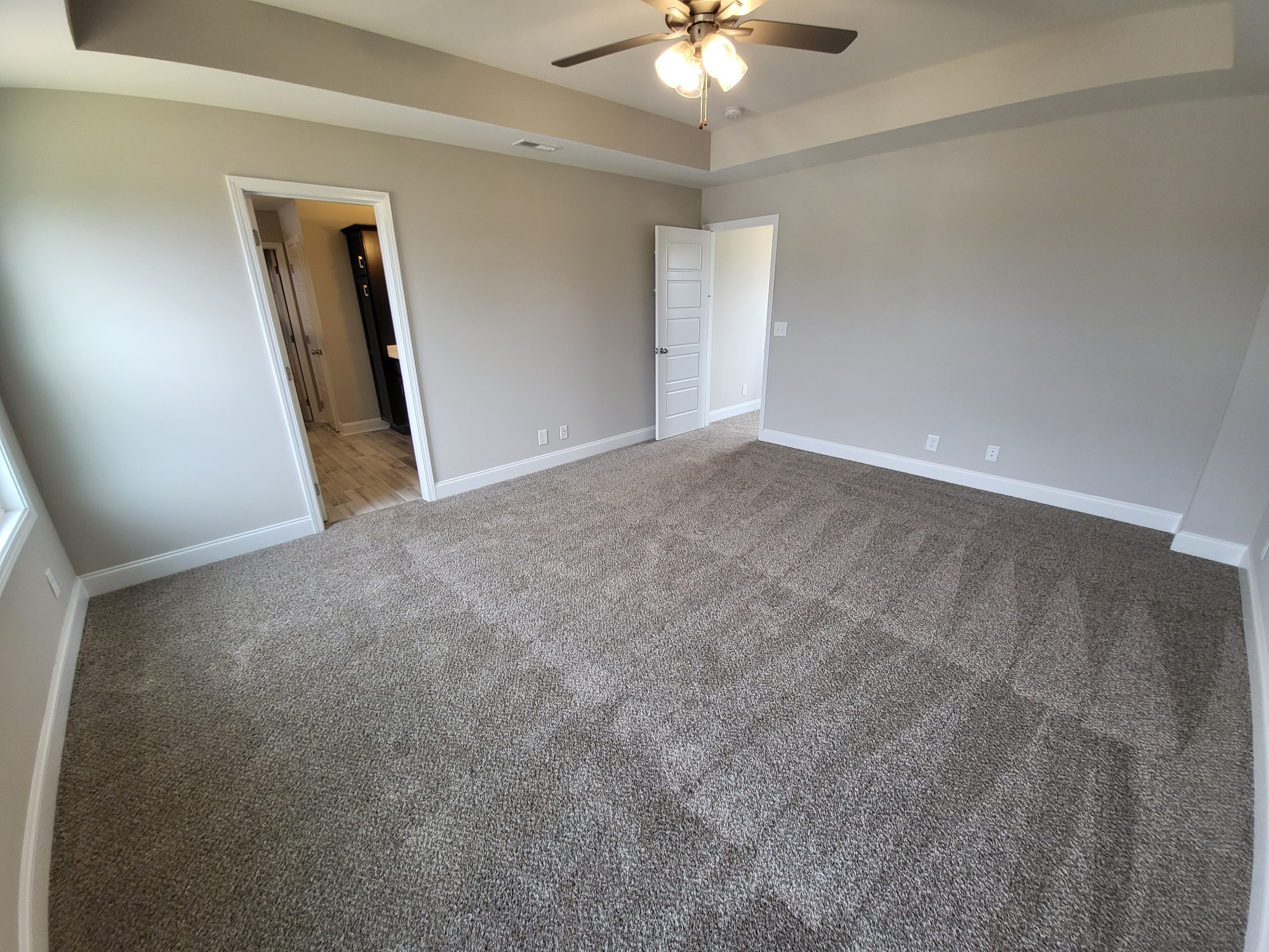 201 King Road Clarksville, TN 37042 - Photo 12 of 26 an empty room with a chandelier fan and a large mirror