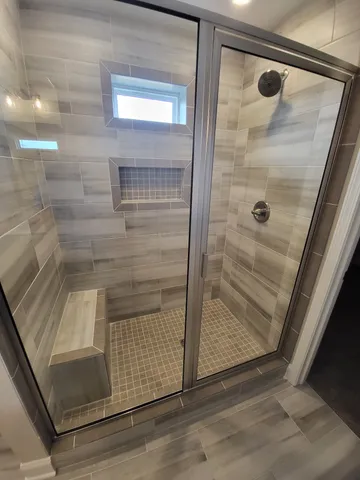 a bathroom with a glass shower door
