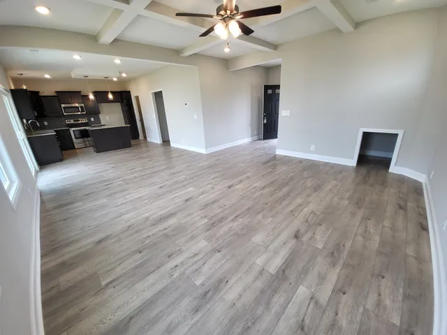 a view of a room with wooden floor