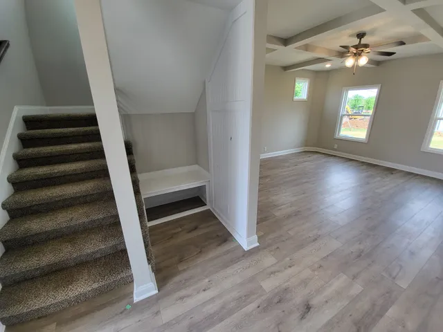 wooden floor in an empty room with a window