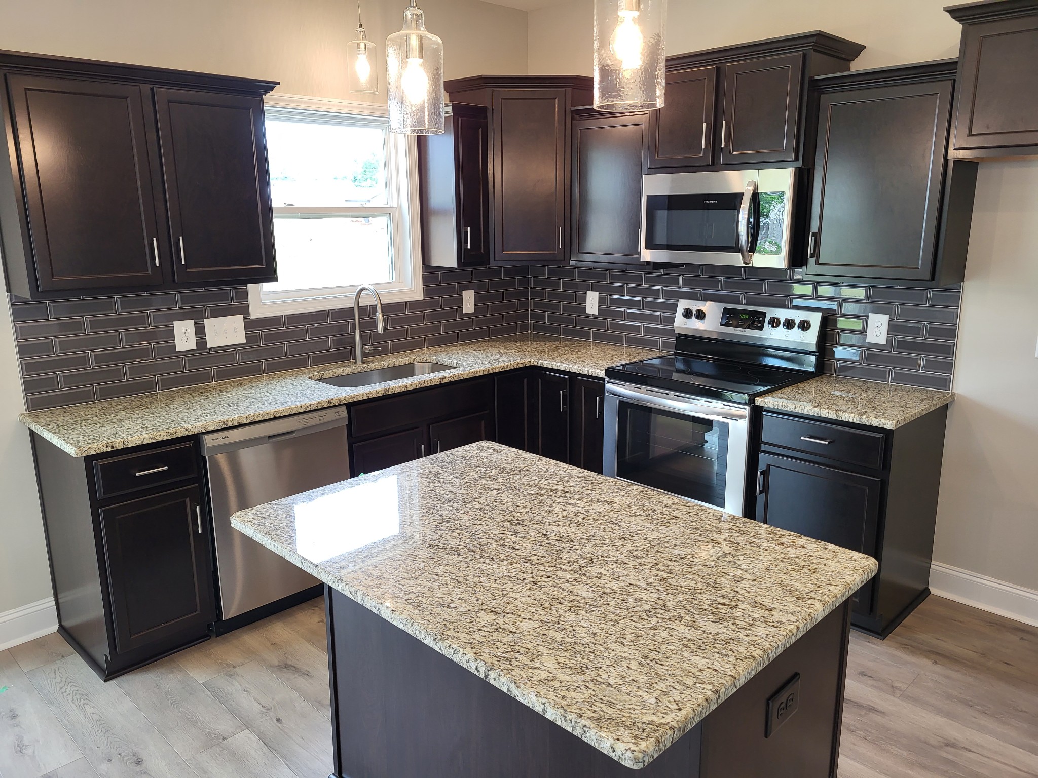 201 King Road Clarksville, TN 37042 - Photo 8 of 26 a kitchen with stainless steel appliances wooden cabinets granite counter tops and a sink
