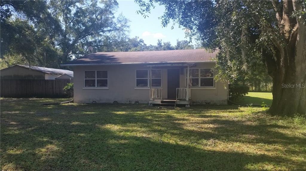 1206 Jerry Smith Road Dover, FL 33527 - Photo 1 of 1 a backyard of a house with yard table and chairs