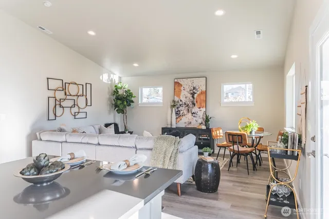 a living room with furniture and wooden floor