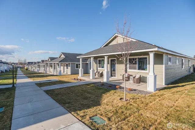 a view of a house with swimming pool and sitting area