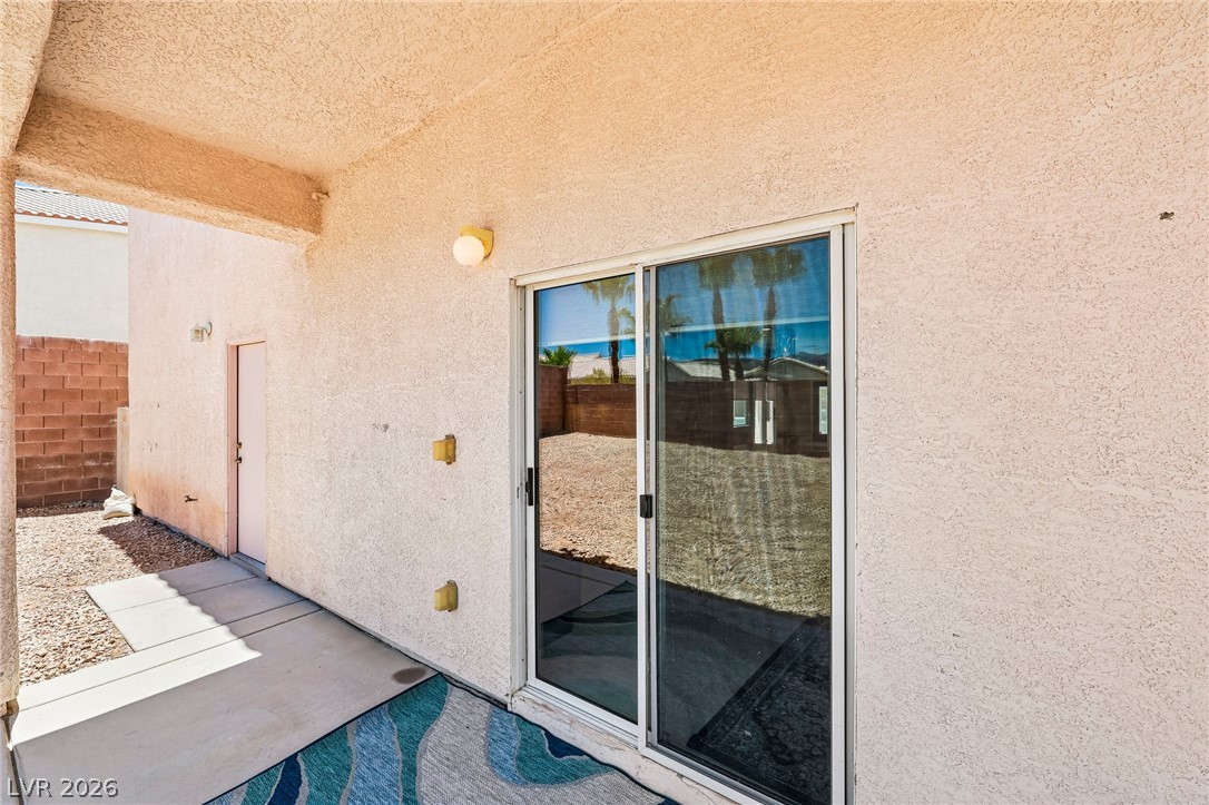1176 Butternut Ranch Court Henderson, NV 89052 - Photo 39 of 60 A private outdoor space with a gravel yard and a covered patio for relaxed living.