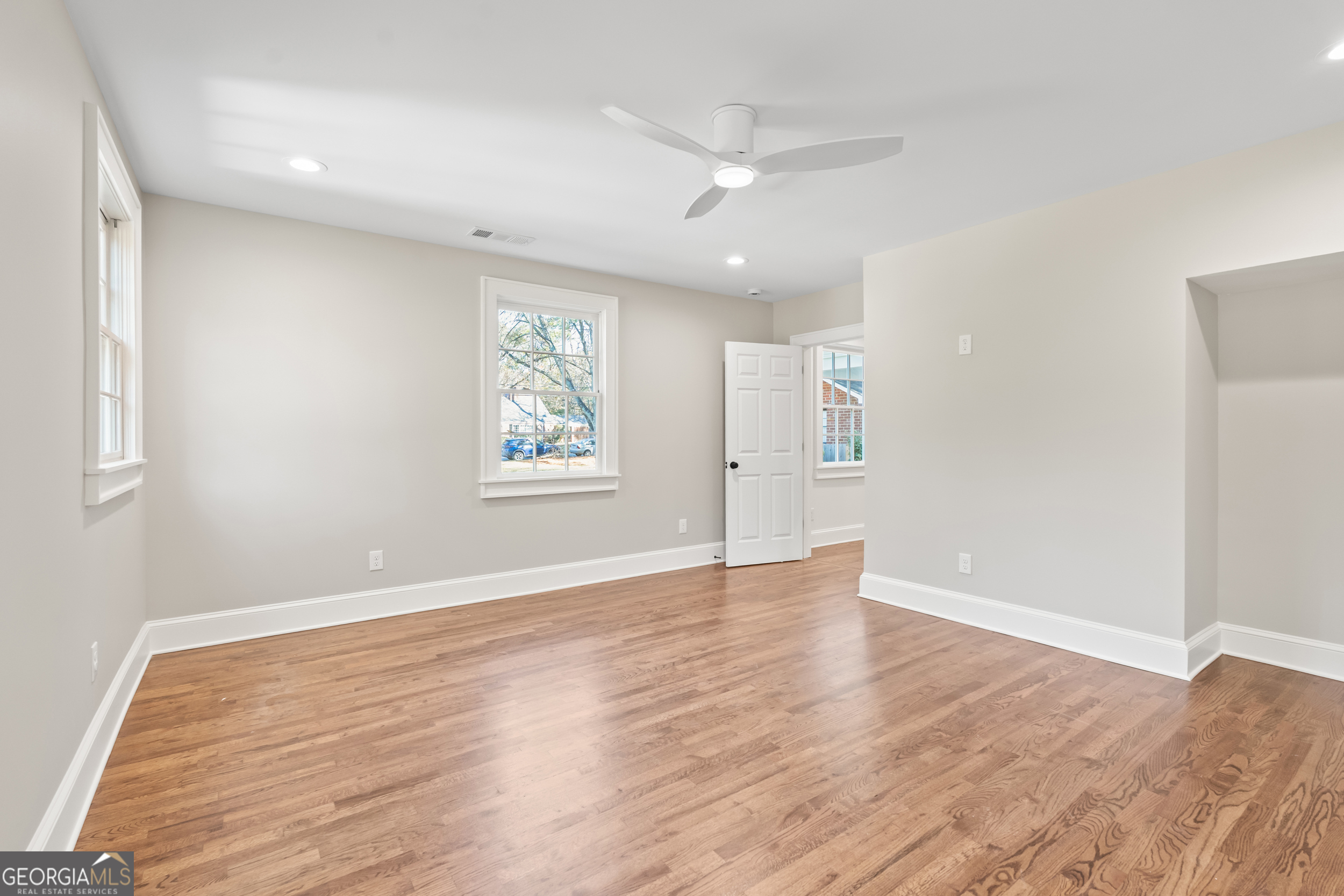 265 Springdale Street Athens, GA 30606 - Photo 21 of 43 an empty room with wooden floor chandelier and windows