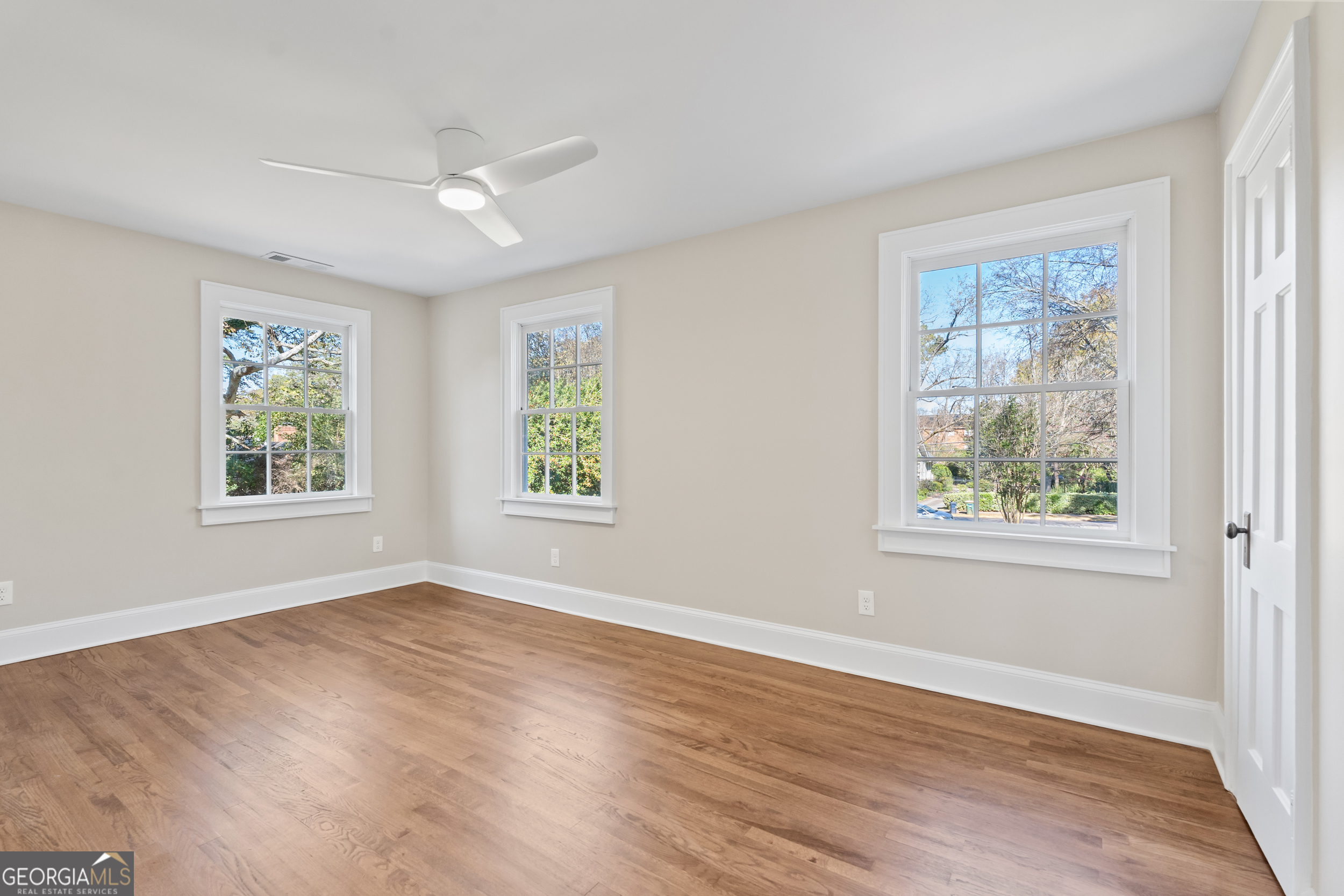265 Springdale Street Athens, GA 30606 - Photo 33 of 43 a view of an empty room with wooden floor and a window