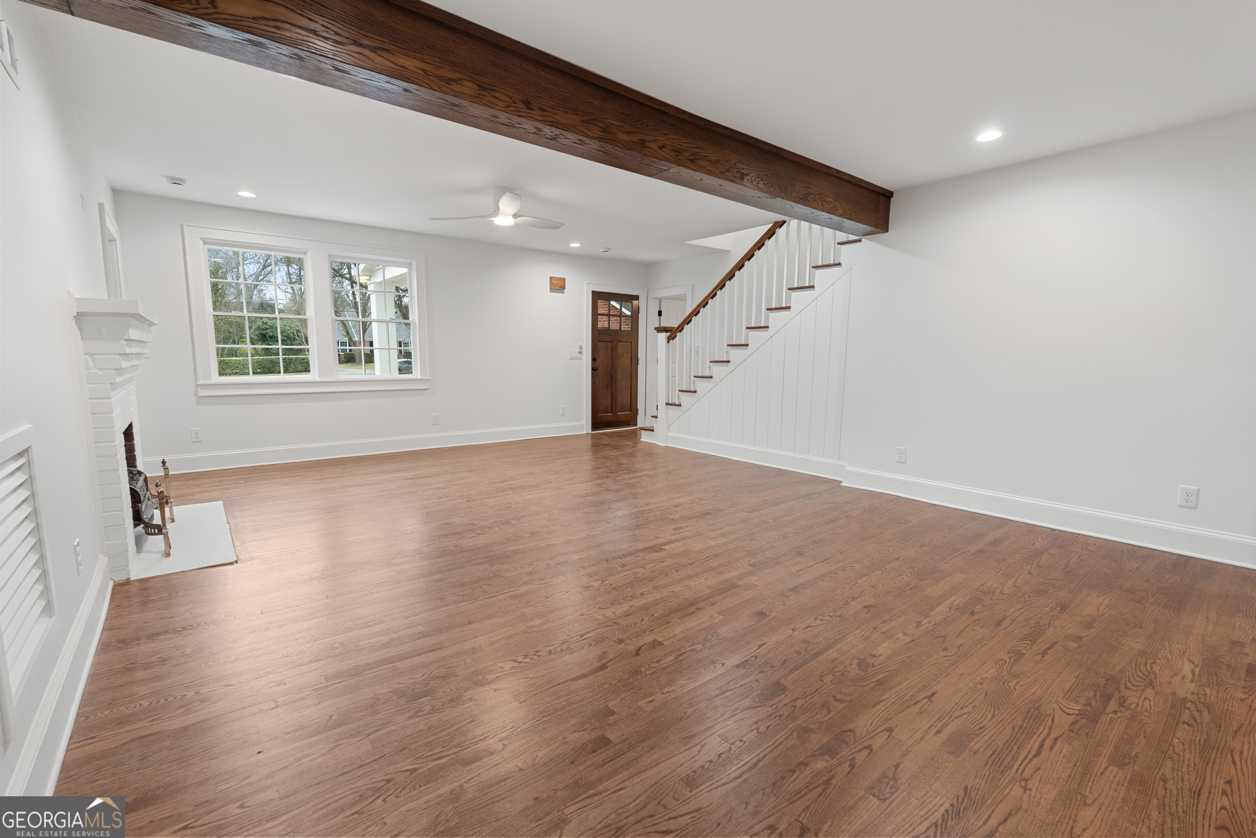 265 Springdale Street Athens, GA 30606 - Photo 4 of 43 a view of an empty room with wooden floor and a window