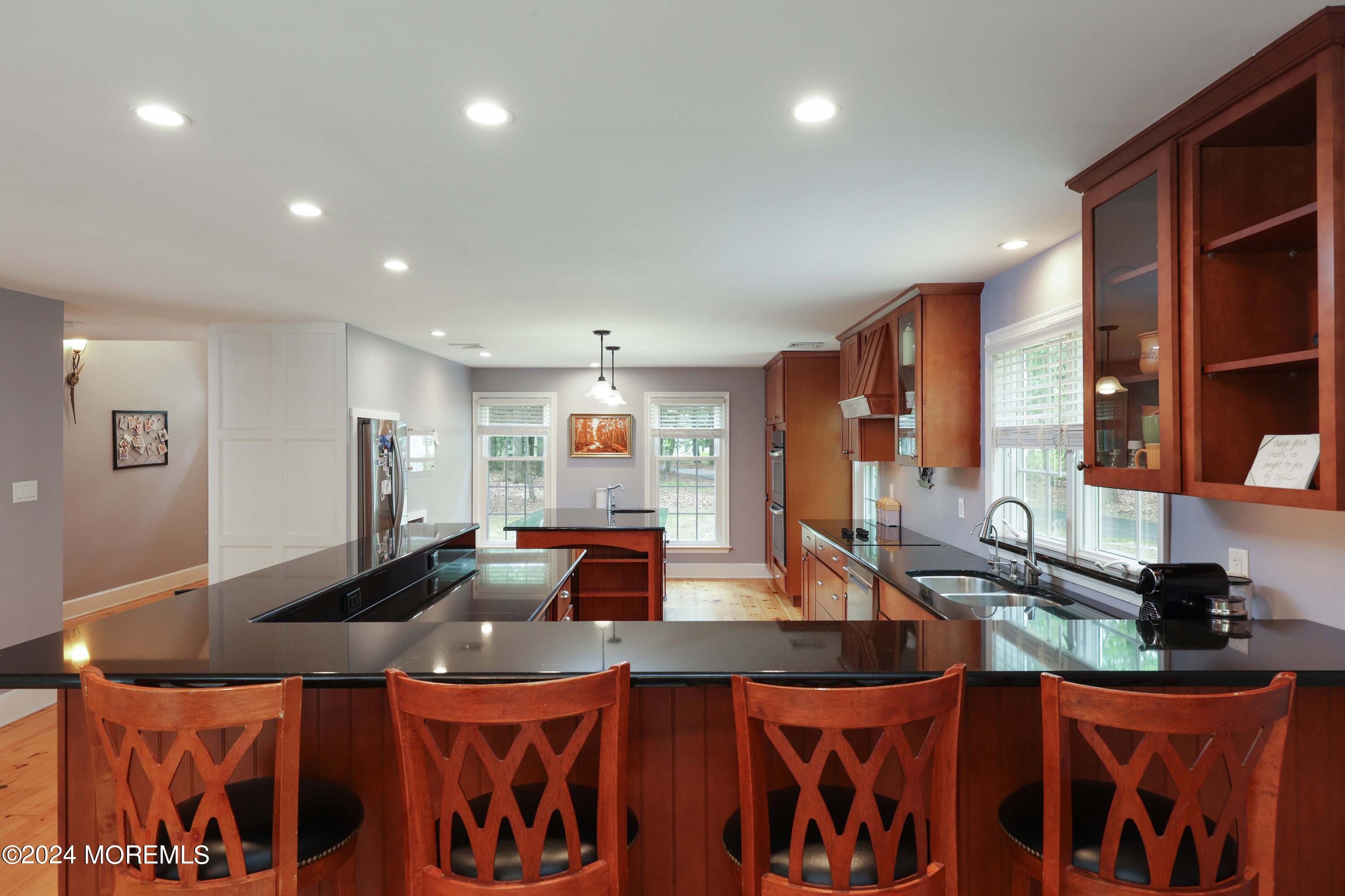 211 Georgia Road Freehold, NJ 07728 - Photo 12 of 41 a kitchen with stainless steel appliances granite countertop a sink and cabinets