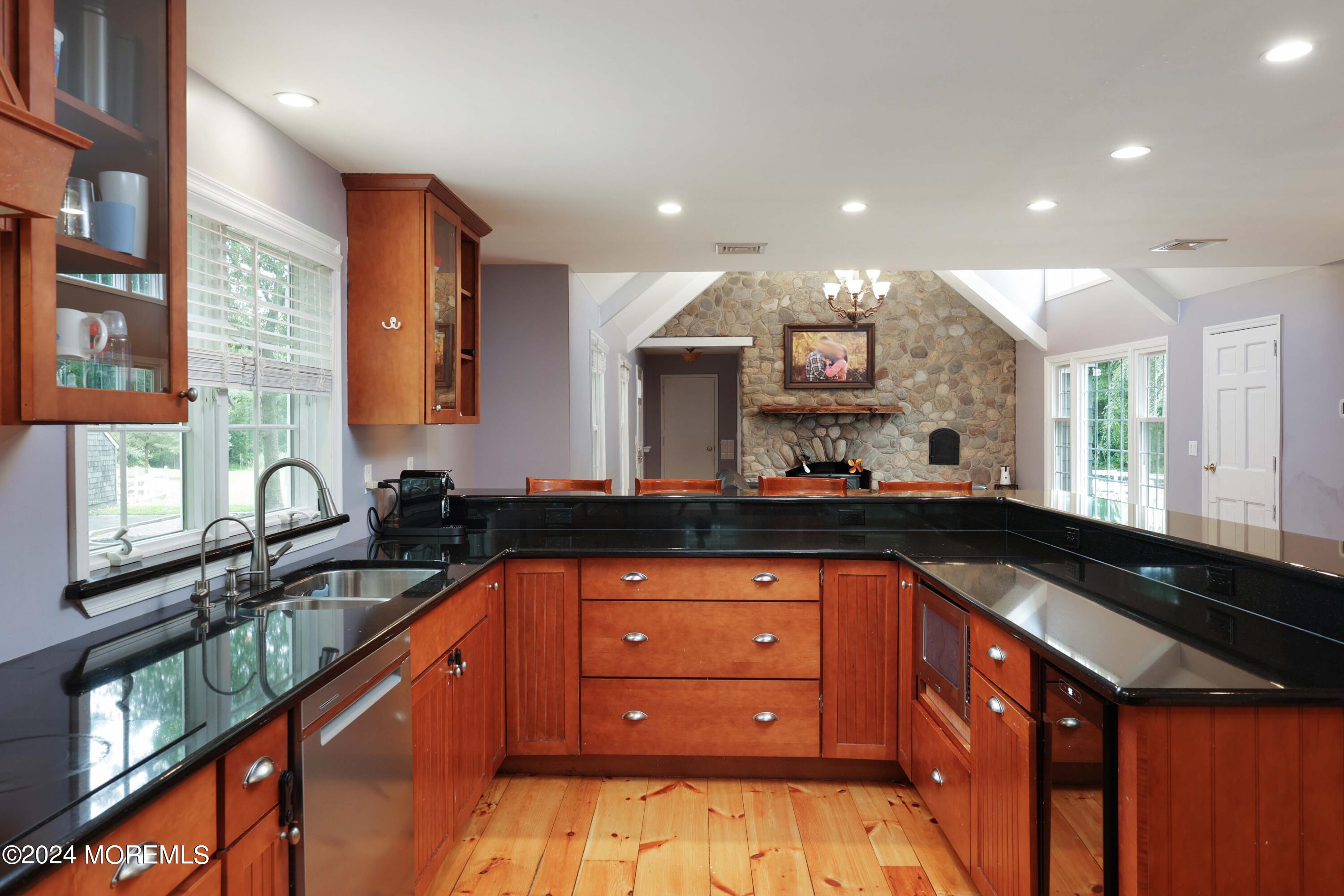 211 Georgia Road Freehold, NJ 07728 - Photo 13 of 41 a kitchen with granite countertop a sink and a stove