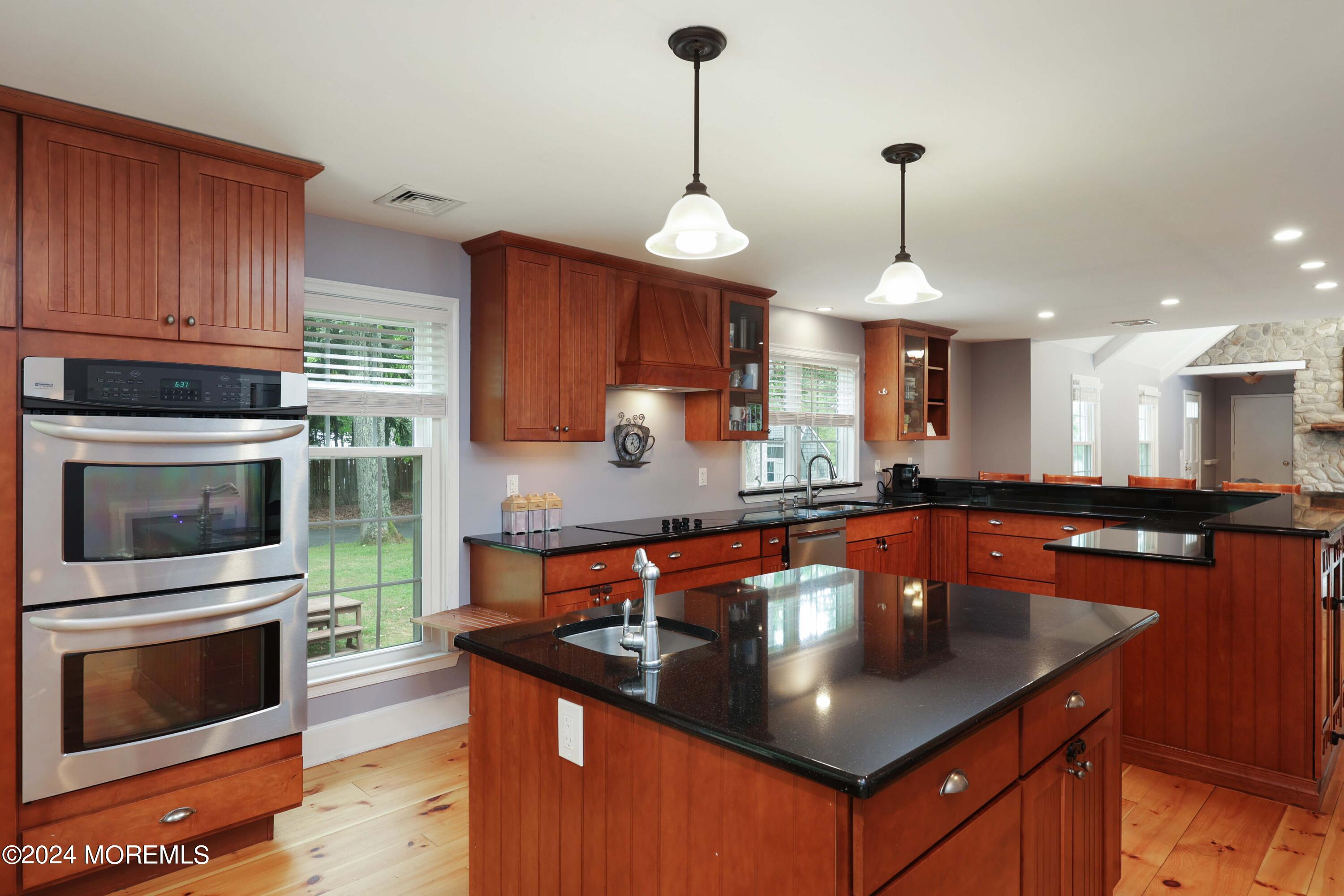 211 Georgia Road Freehold, NJ 07728 - Photo 14 of 41 a kitchen with stainless steel appliances granite countertop a sink a microwave a stove and a center island