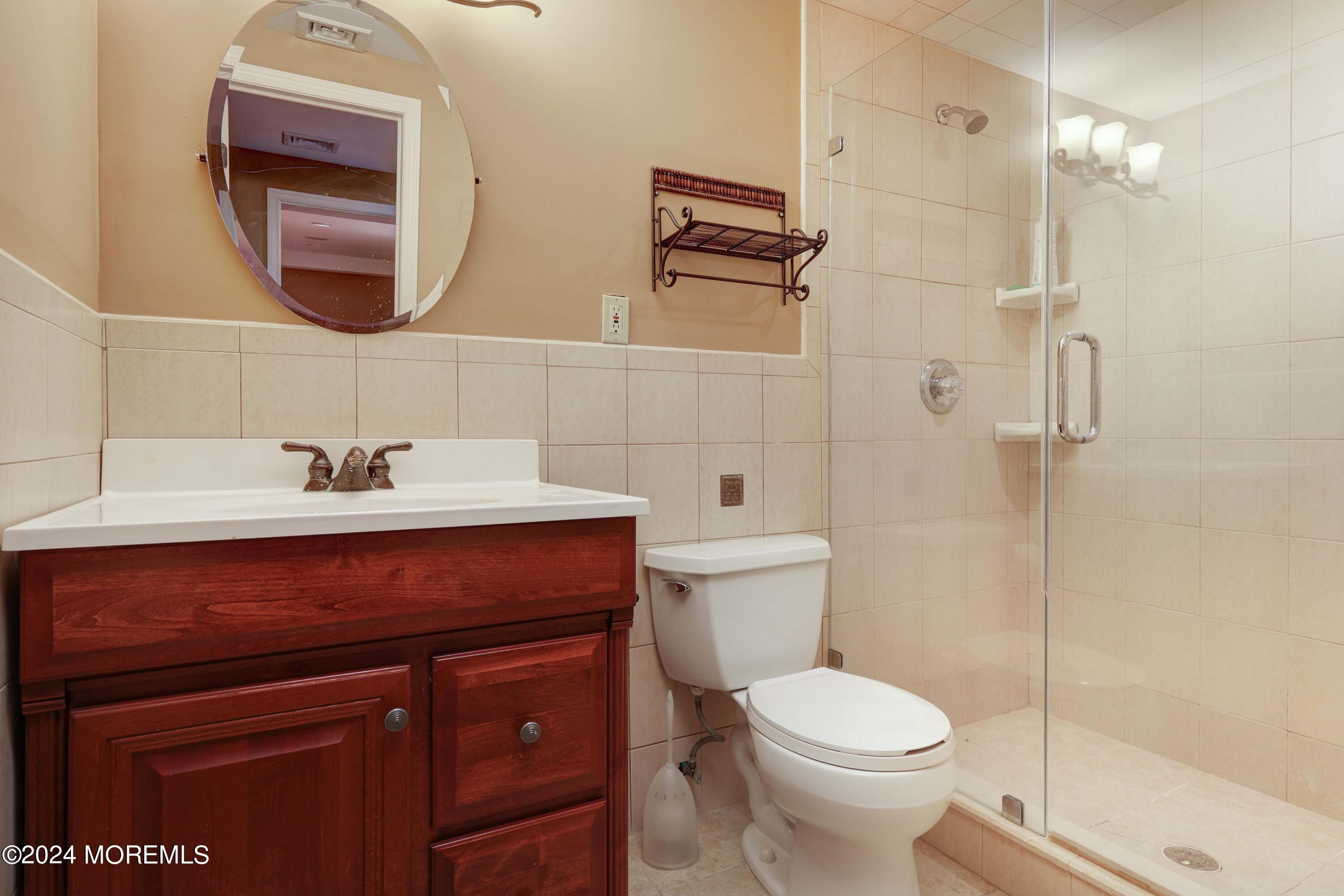 211 Georgia Road Freehold, NJ 07728 - Photo 29 of 41 a bathroom with a sink a toilet and shower